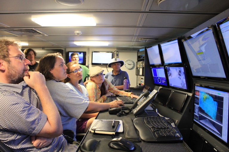 Lead Marine Technician Colleen Peters shows the science party how to work the video matrix in the control room. 