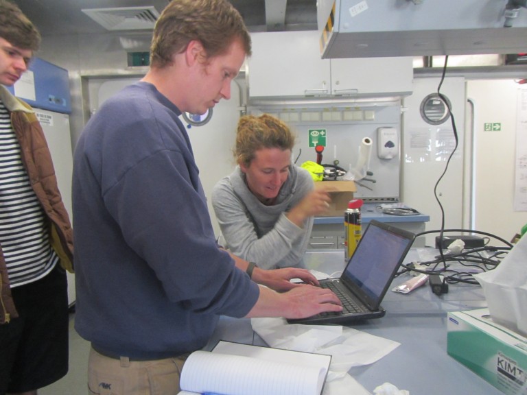 Amy Waterhouse and Sam Kelly prepare a computer that will download data from an ADCP deployed on the CTD rosette to measure water velocity.