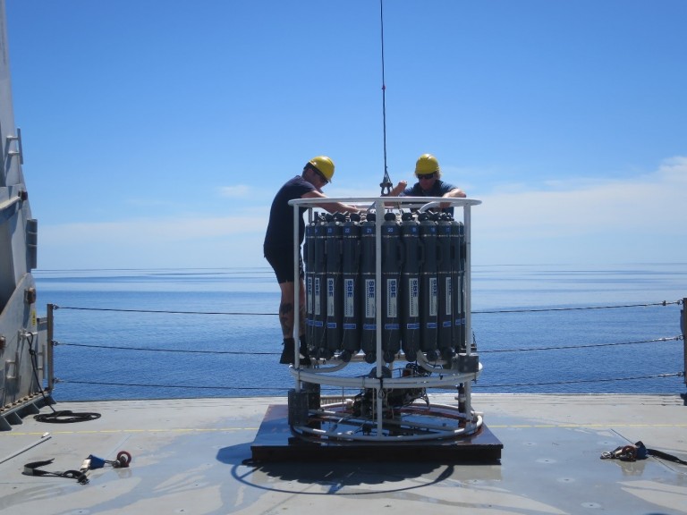 The science team prepares the CTD for deployment.