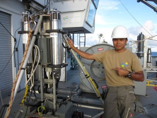 Deckhand Archel stands next to one of the landers that are carefully released into the Mariana Trench and brought back onto Falkor. 
