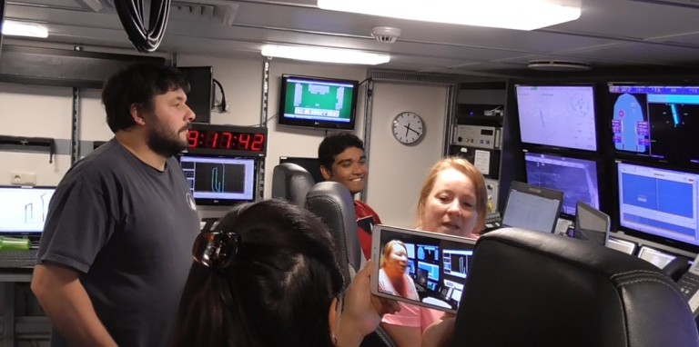 University of Houston masters student Vaughn Robla describes her duties as watchstander to students during a ship to shore connection. 