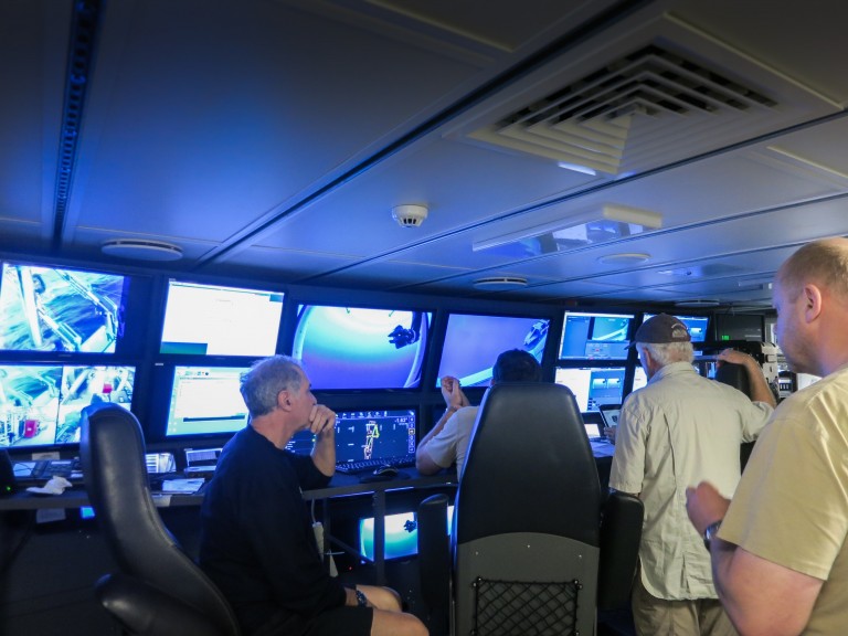 University of Western Australia Professor and Chief Scientist Malcolm McCulloch watches live footage in the control room from the first ROV test dive, along with the rest of the science team.