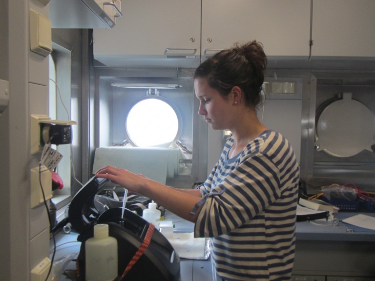Danielle Mitchell loading a sample into a fluorometer to measure chlorophyll. 