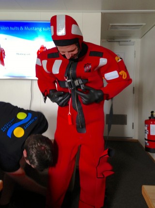 Daniel Wagner tries on a "Gumby" survival suit. 