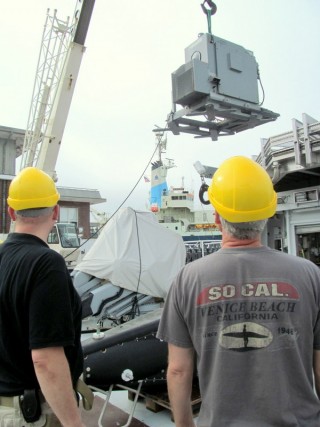 R/V Falkor crew and WHOI staff offload a winch that was used to operate the Video Plankton Recorder (VPRII).