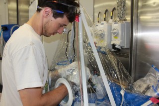 Researcher Michael Ottman from the University of Minnesota works to clean water samples in the nitrogen filled glove bag.