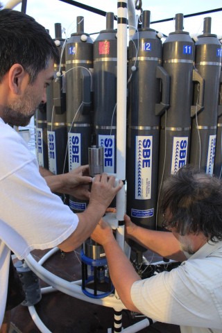 SOI marine technicians Pete Keen and James Cooper work on attaching one of the newer eH and pH sensors to the CTD.