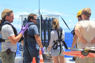 On a nice day, everyone gathers around the CTD to discuss the next strategy. University of Hawaii postdoctoral fellow Arne Sturm, pulls off his gloves after collecting all his samples.