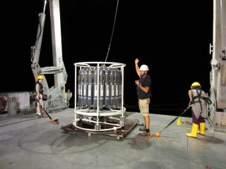 Dr. Patty Fryer, Phil Guenther and Oceanographer Eleanna Grammatopou prepare for a night deployment of the CTD.