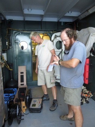 Marine Technician Nicolas Hannekum and Dr. Clifton Nunnally check the data from the top-side unit for the dunker.