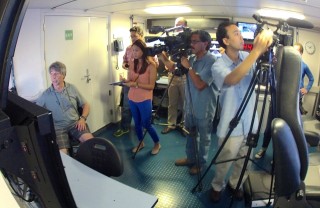 Chris Kelley explaining the expedition's accomplishments to the press in Honolulu. 