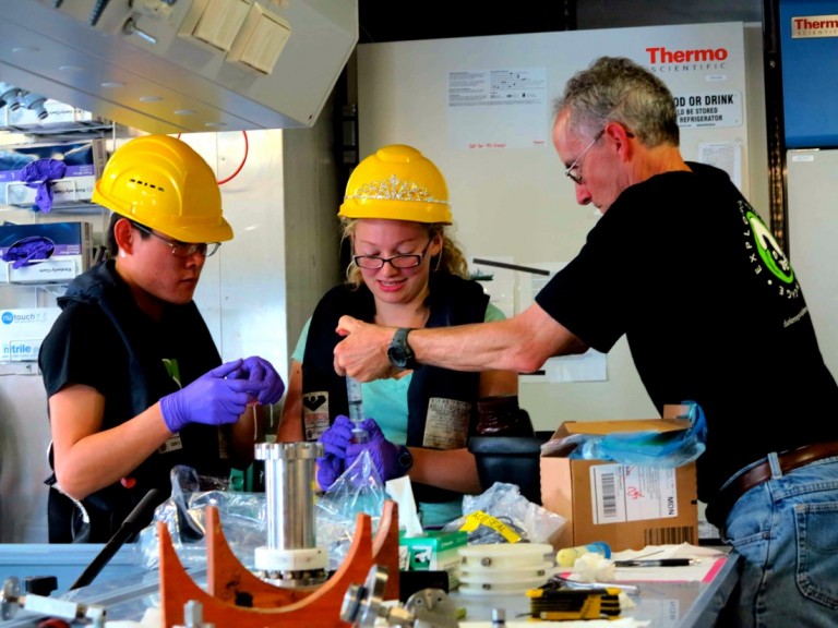 Processing newly collected water samples in the wetlab. From left to right: Than Kyaw, Bethany Kolody, and Doug Bartlett.