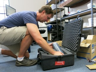 Dr. Jim Falter packing scientific equipment for the cruise. 