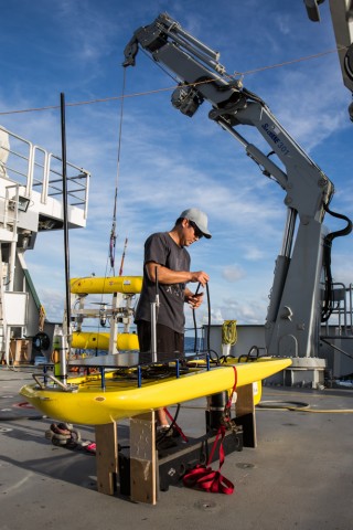 effery Oshiro prepares the “Float” portion of the Wave Glider on the aft deck of Falkor while on the Coordinated Robotics cruise.