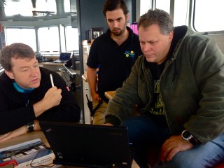 Capt. Bernd Buchner, Chief Officer Philipp Günther, and ROPOS team Asst. General Manager Keith Tamburri analyzing weather forecasts. 
