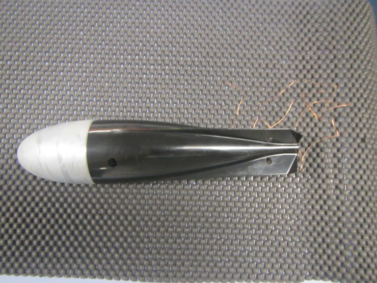An XBT unit with weighted head and thin copper thread at tail.