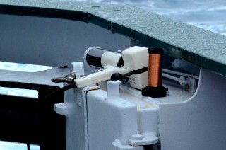 On the right is one of the coils of thin copper wire that plays out during an XBT deployment. The wire drops out of the white gun-shaped unit on the left, which is wired into the ship to temperature and depth data