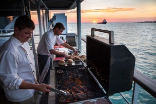 The science team and crew take a break after a hard day of work for a sunset barbecue.