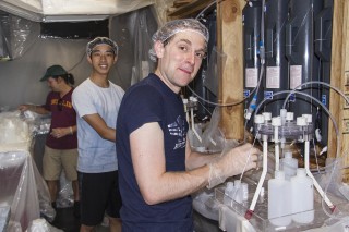 Dr. Tristan Horner leads Student Participant in managing water samples in The Bubble. "At first it seemed excessive, but now I appreciate how our caps and all the precautions we take not to contaminate our water samples," said Hsu.