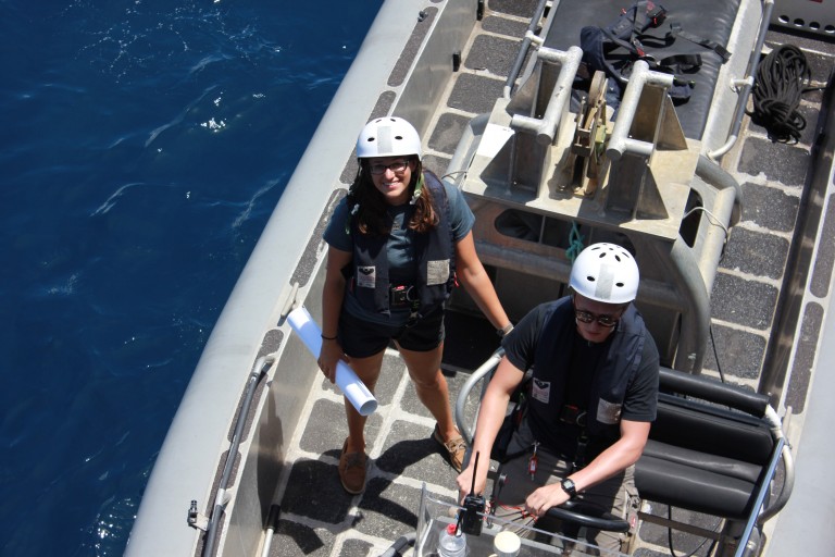 Student Opportunities participant Julianna Diehl assists with launching the small boat.