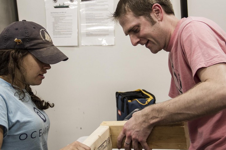 Noelle Held and Tristan Horner while perofrm construction while the "bubble" to protect against trace metal contaminants the first day at sea. 