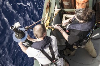 Marine Technicians Veit Huehnerbach and Tonya Watson deploy one of the Argo Floats.