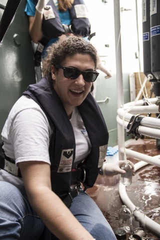 Sarah Laperriere taking water samples from the rosette onboard R/V Falkor. 