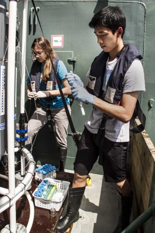 Caleb assists Dr. Alyson Santoro gathering water samples once the CTD rosette is back onboard.