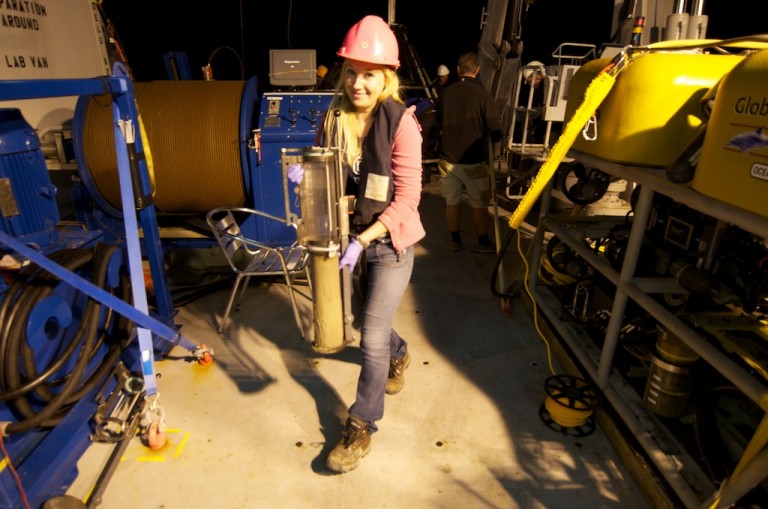 Postdoctoral researcher Sara Kleindienst carries a multicorer sediment sample to the wet lab for processing. 