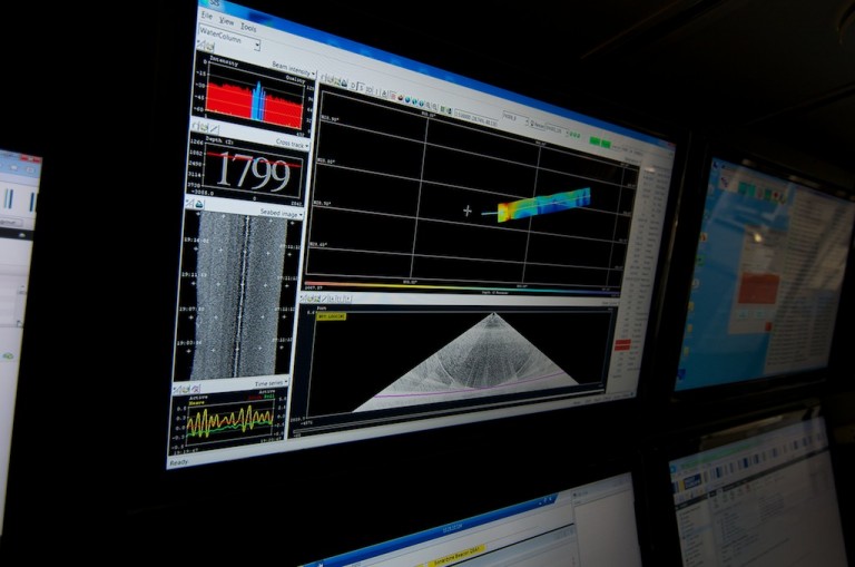 Scientists monitor the graphical display that shows the results from high-resolution mapping of the seafloor.