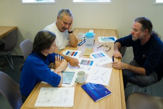 Susan Allen, RIchard Dewey, and Jody Klymak (left to right) working in the galley. 