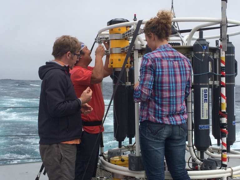 Amy and Randall help Spencer reinstall the LADCPs onto the rosette (note the custom brackets) after changing the internal batteries.