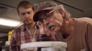 The science team investigates the cameras in preparation for the cruise. 