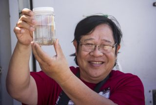 Dr. Lam Nguyen-Ngoc admires zooplankton collected in the first tow of the expedition