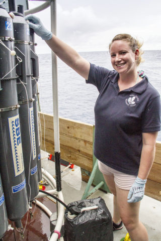 Kimberley Bird collects water samples from a CTD cast to gather information about the underlying water column. She focuses on how microbes carry out important ecosystem functions throughout the marine environment.