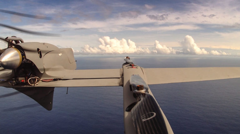 An HQ-60B drone flies over the Pacific Ocean, away from the effects that Falkor or clouds could have over data being collected. The aircraft flies an average of two hours in each mission carrying a payload of radiation, hyperspectral or infrared cameras.