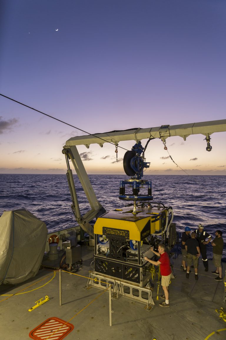 Research scientist Ben Larson starting sample retrieval under the crescent moon and Venus