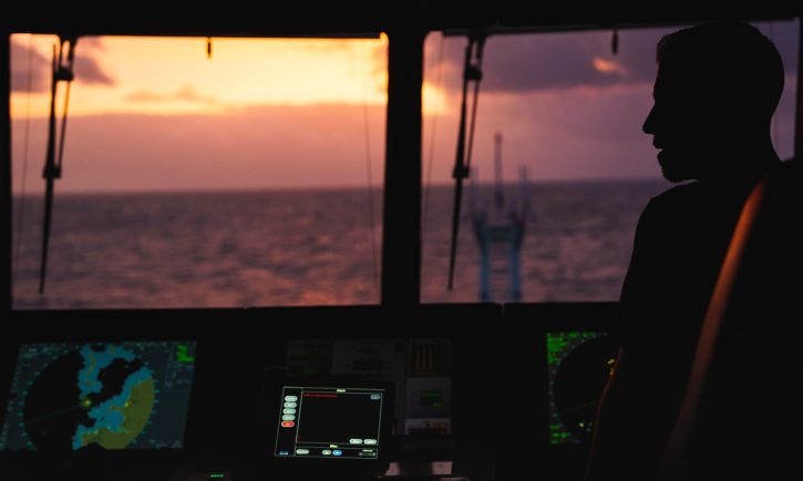 Jason Garwood (Chief Officer), silhouetted against the evening sky, as he and his team take Falkor (too) into the Atlantic.