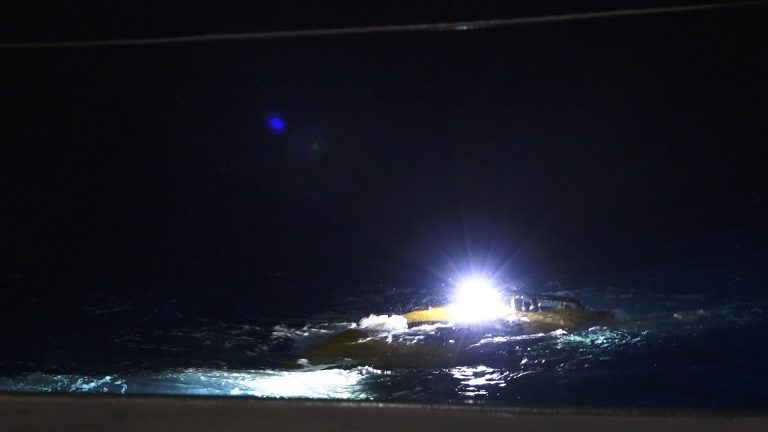 ROV SuBastian begins its slow descent at night. 