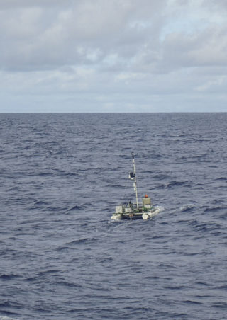 The Remotely Operated Catamaran, driven by Dr Mariana Ribas, working in moderate sea states in the Pacific Ocean. The catamaran collects samples of the Sea Surface Microlayer through a system of rotating glasses.
