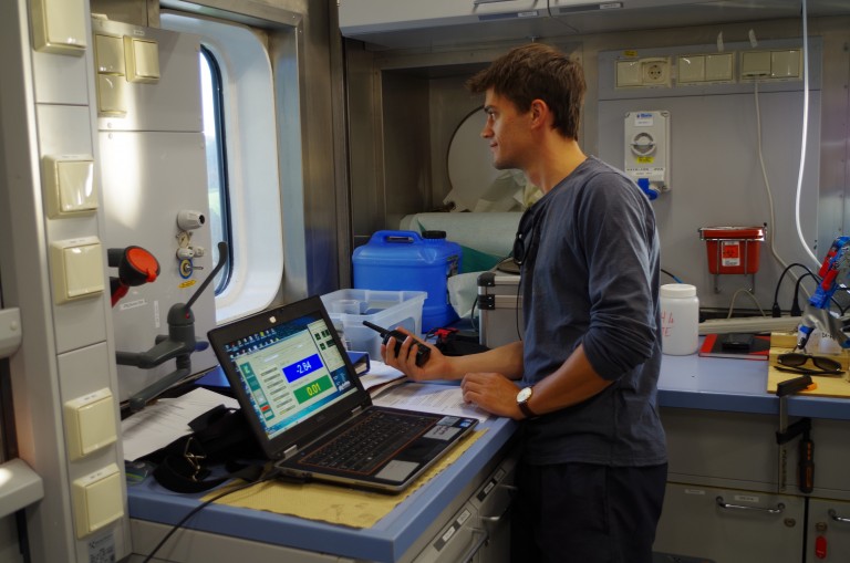 Researcher Joey Voermans monitors incoming data in the Falkor wetlab. 