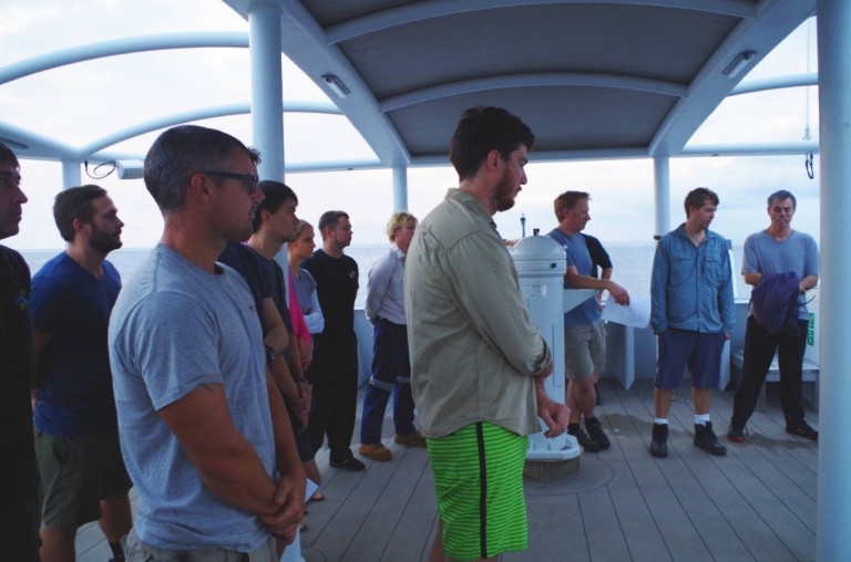 Scientists and crew reflect with a minute of silence.