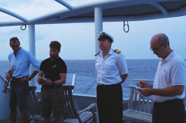 Taigh MacManus reads “Poem on the Gallipoli” with Captain Bernd Buchner, Chief scientist Greg Ivey, and Richard Brinkman.