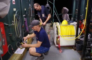Skilled marine technicians, Josh and Veit, prepare the ROV for the evening dive. 