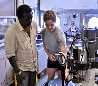 Jill showing Bryan the titanium fluid samplers that she, Jeff and Sean will be using to collect high-temperature vent-fluids from across the Von Damm and Piccard hydrothermal fields. The number 7 is significant. Jeff brought 6 bottles on this cruise, but 7 is the number he hopes to return home with: we left 1 behind in 2009 that needs collecting.