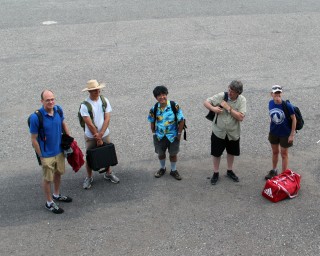 Key members of the escape committee: Mike, Daniel, Ko-ichi, (Bruno) and Loral. Five minutes after I took this photo, Loral came running back from the dock gates toward us. Bless her, I thought – she really misses us that much already. Not so much, actually – she had just left her phone in the library ☺