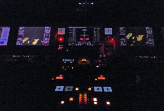 A portion of the controls on the bridge of the Falkor at night.