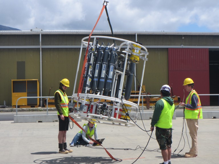 Dmitry Brazhnikov, Cheif Scientist Amy Waterhouse, Spencer Kawamoto and Sam Kelly calibrate the ADCPs on the dock. 