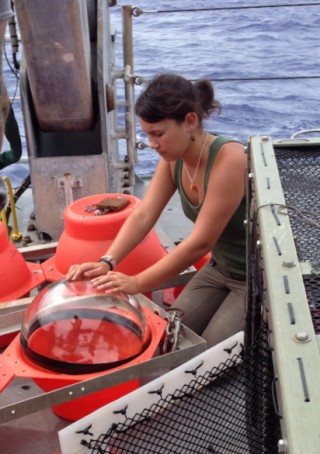 Chloe Weinstock checks the vacuum-sealed glass float and its protective orange case.  The orange is highly visible when the lander is waiting for recovery at the surface. 