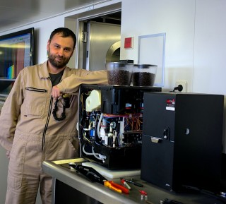 Todor Gerasimov doing maintenance work on Falkor's main coffee machine, which is almost as critical as the scientific equipment.